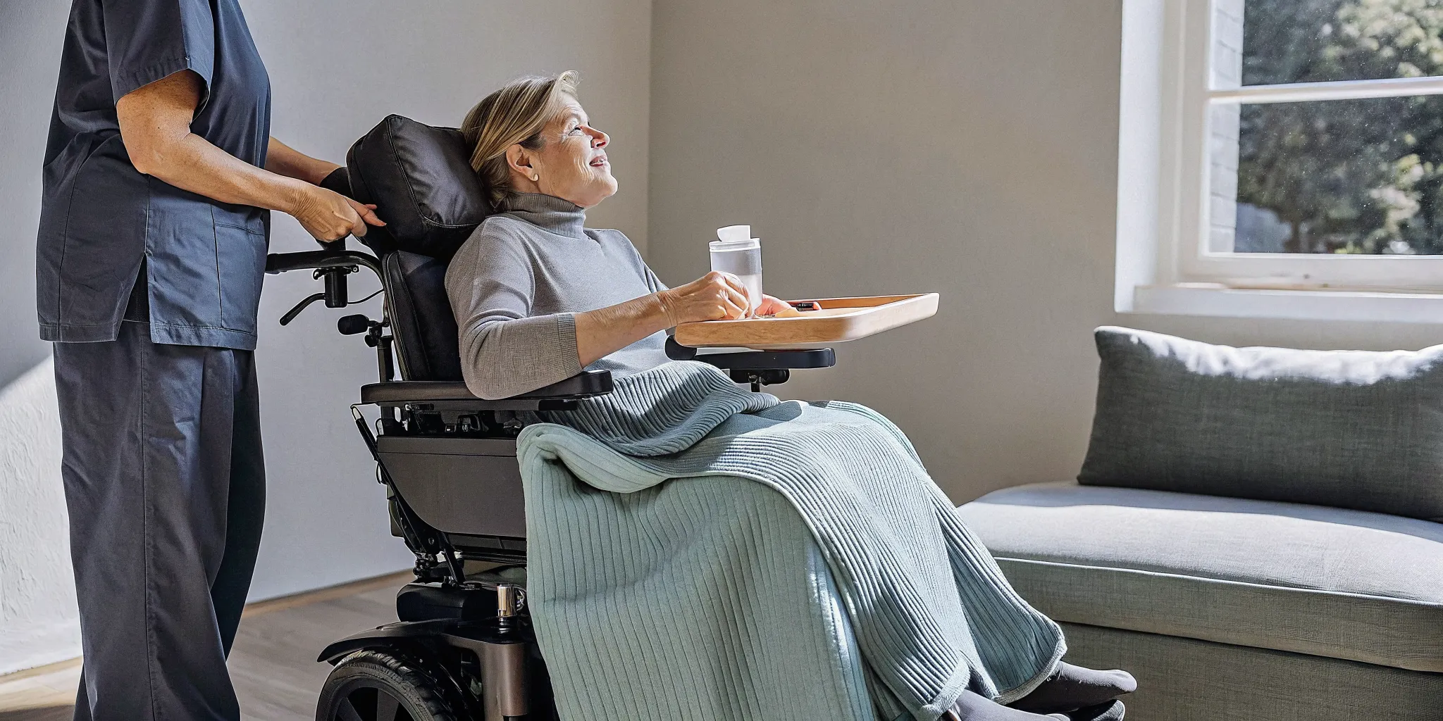 Woman with ALS in a wheelchair receiving personal home care from a caregiver.