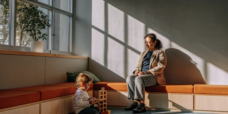 Child receiving developmental health services with support from a parent.