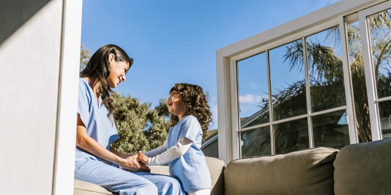 Caring pediatric home health nurse and medically fragile child