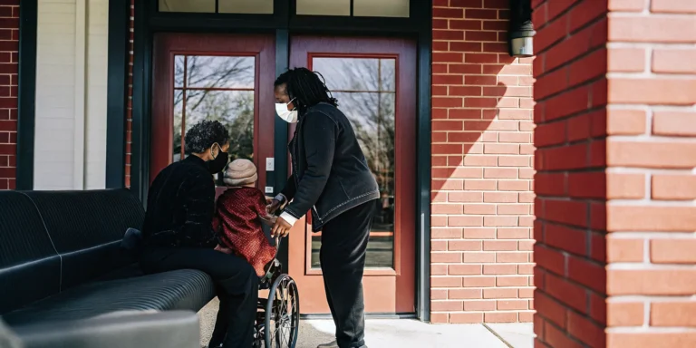 Georgia Department of Community Health building exterior with a family and pediatric nurse at home