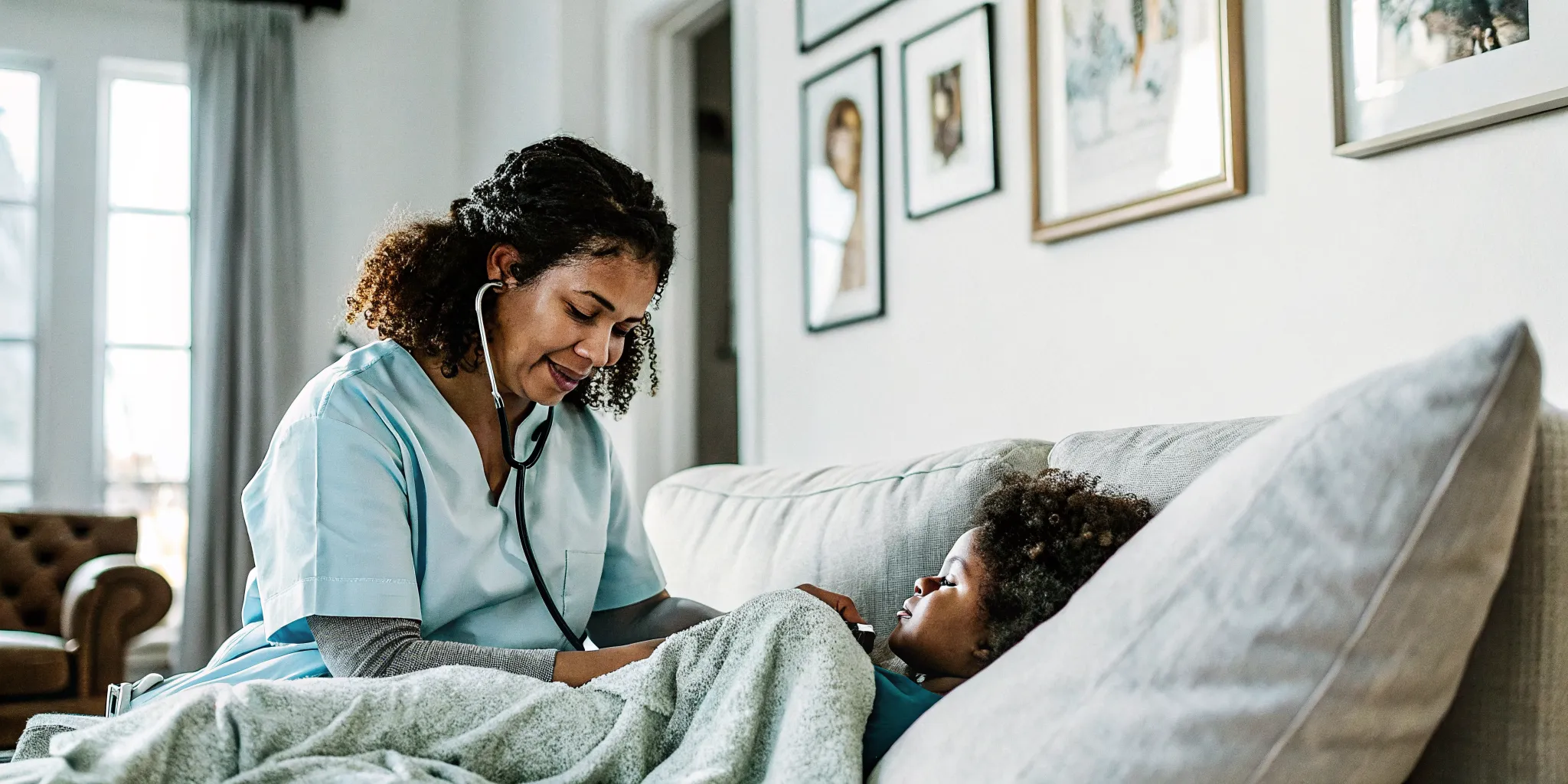 Pediatric nurse seated beside a school-age child resting at home for compassionate in-home care